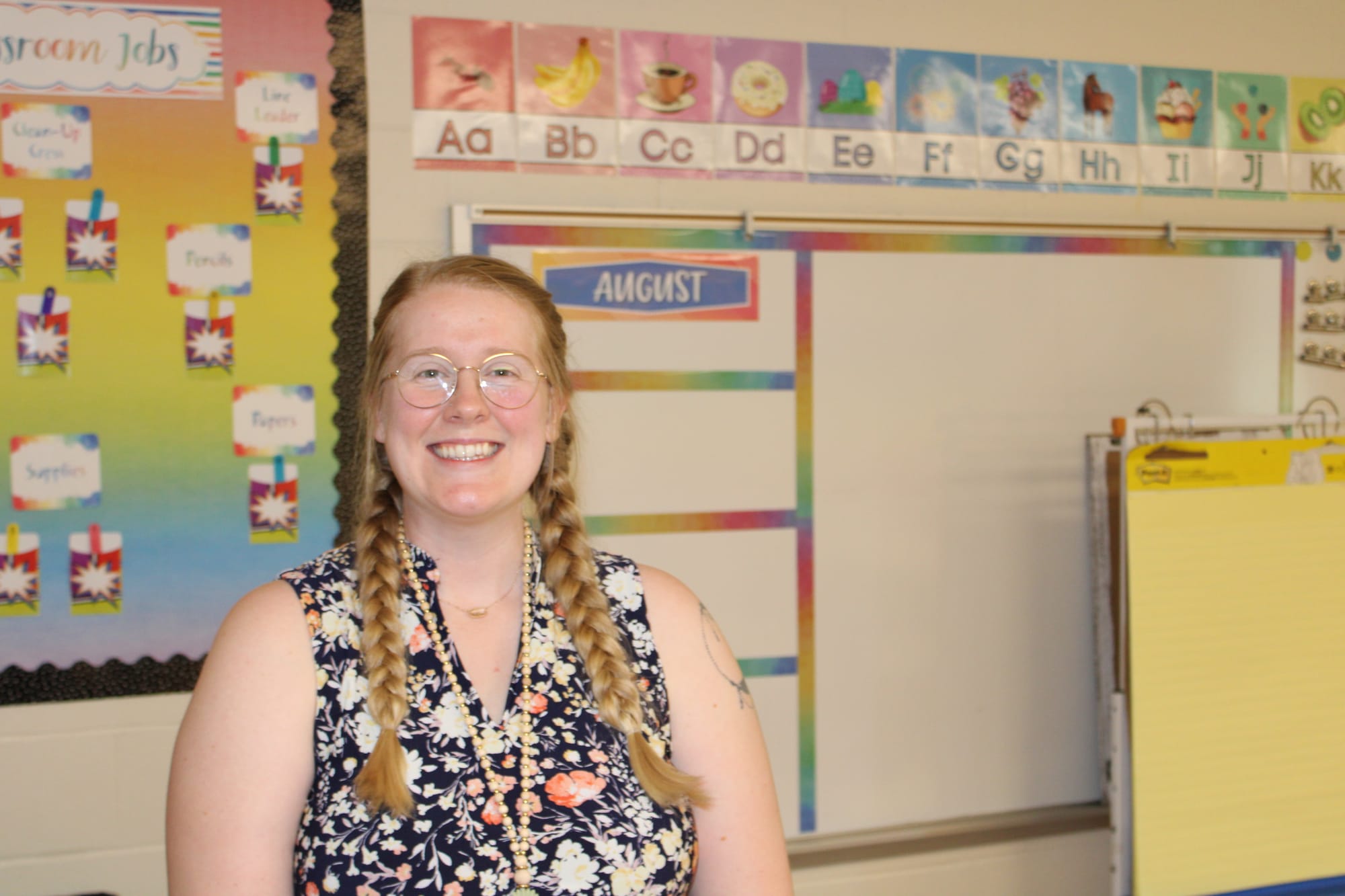 Abbigayle Robinson stands in a classroom in front of a whiteboard