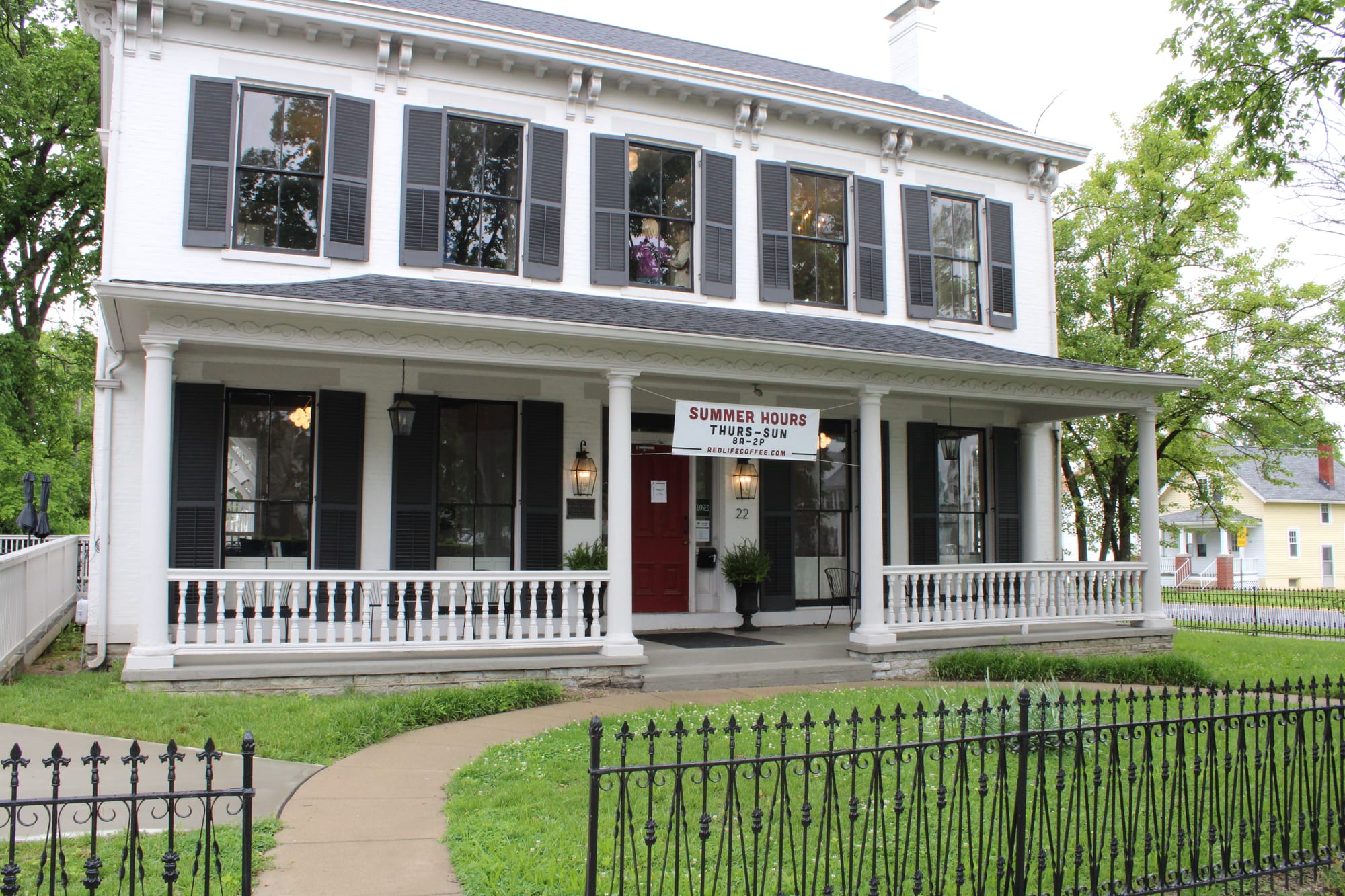 Tom Ellis led a tour of RedLife Coffee in Alexander House, a blue and white house