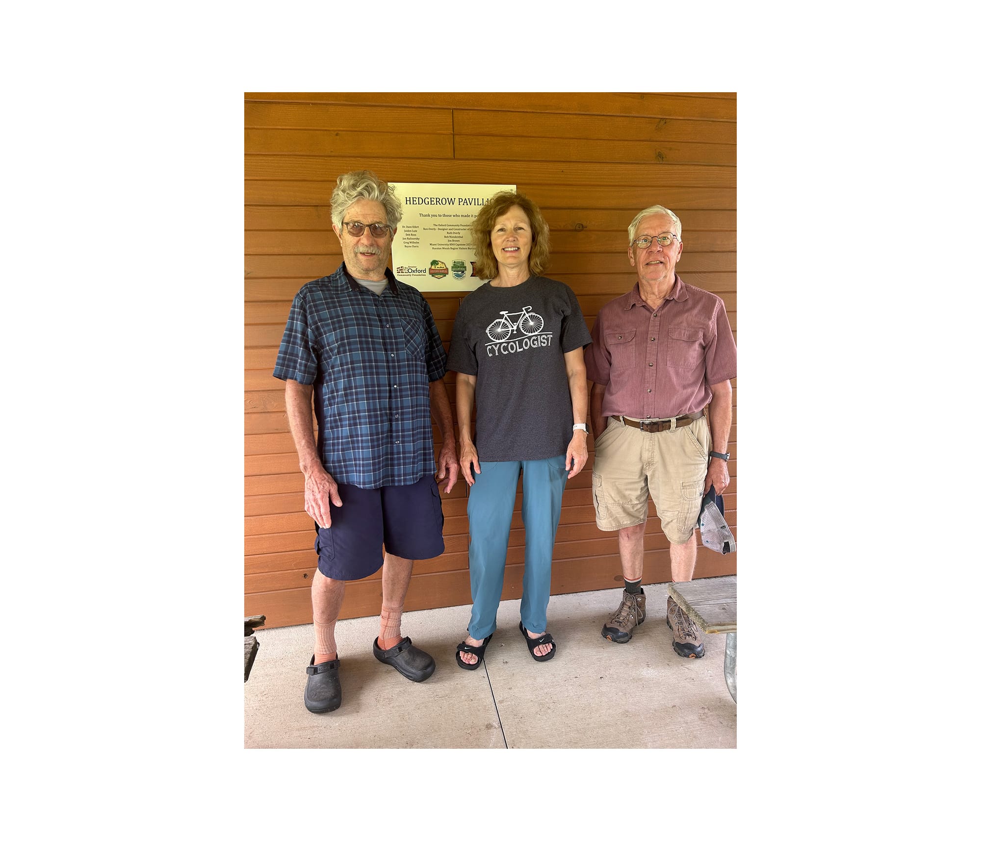 (Left to right) Dave Eifert, Helaine Alessio and Ron Overly stand in front of the plaque at Hedgerow Pavilion.