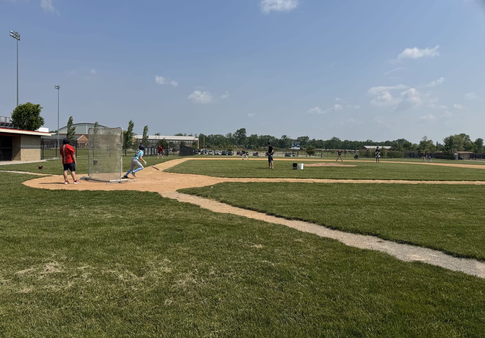 A middle schooler watches his hit in the air from home plate,