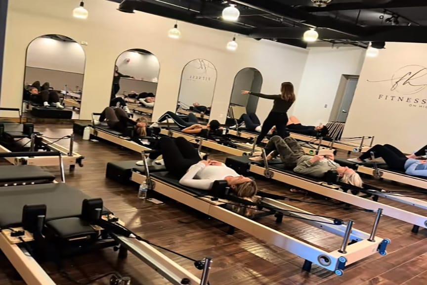 Some classes at Fitness on High use reformers, a piece of equipment with a moving platform.
