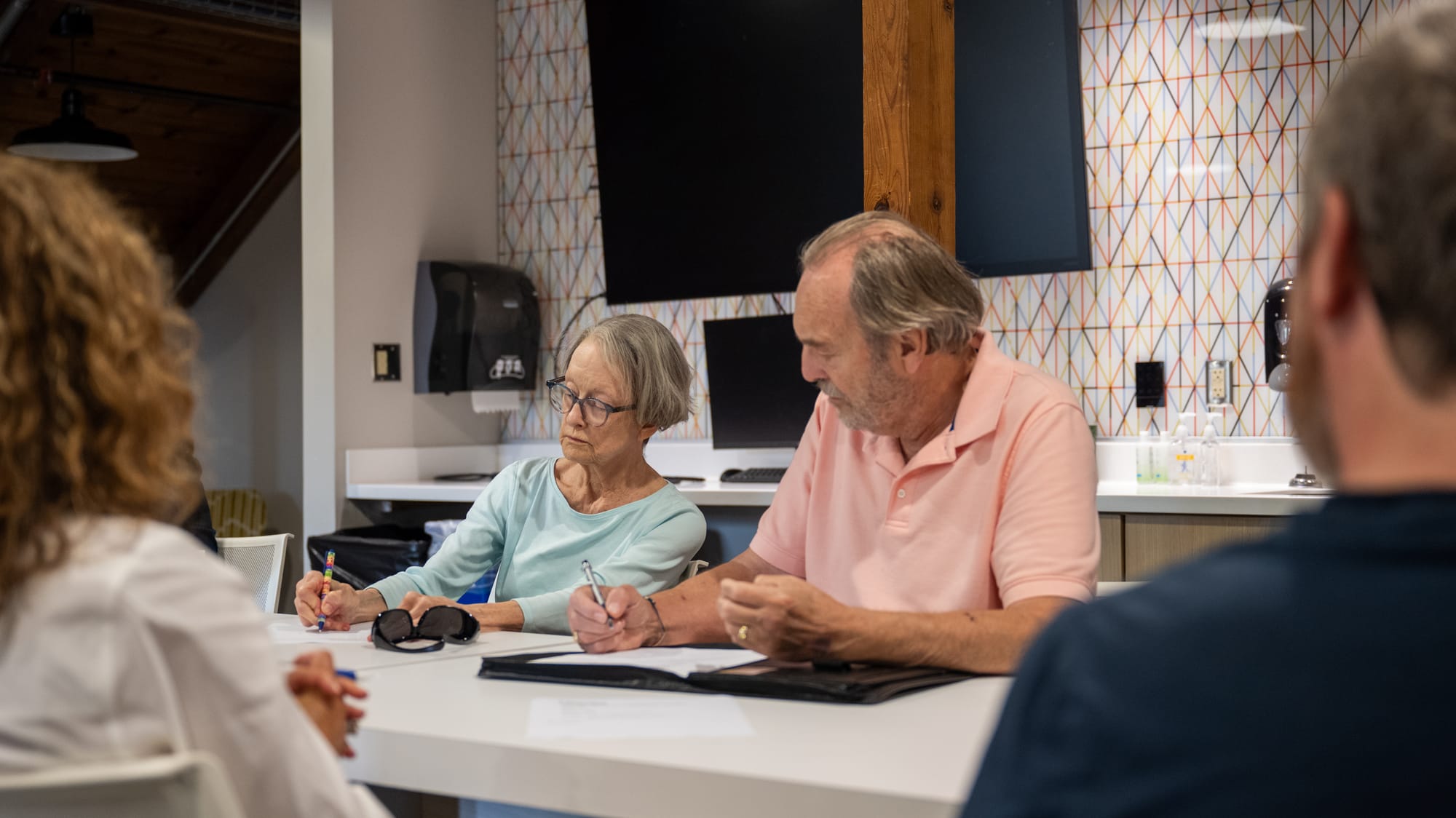 Commission member Anne Bailey (left) and Commission Chair Steve Schnabl (right) look over notes during the Oxford Housing Advisory Commission meeting.