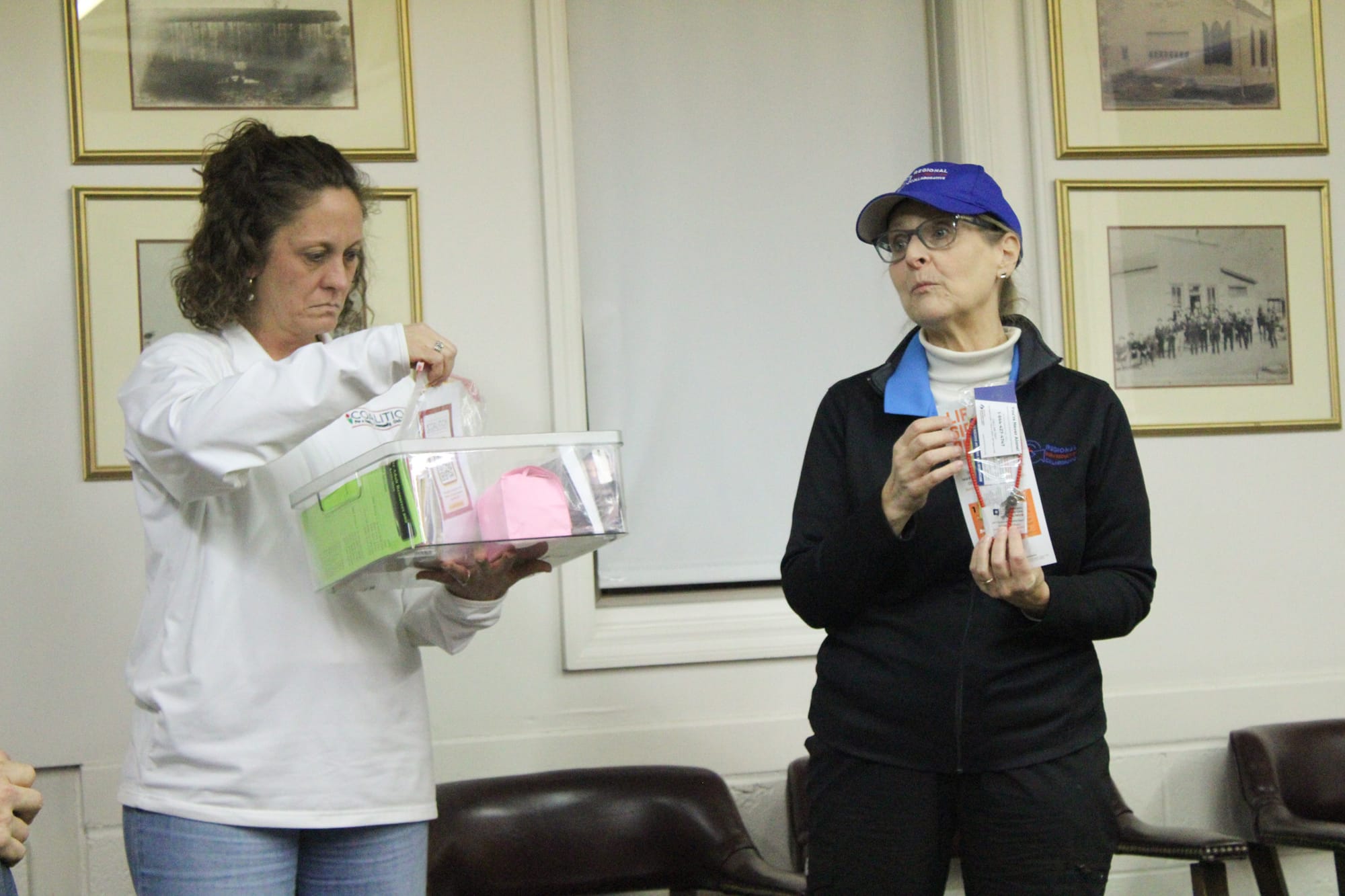 Amy Macechko (left) holds a community safety supply box