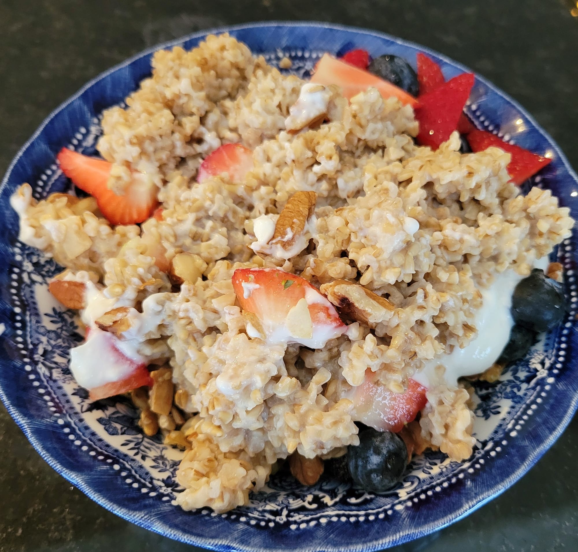 Groats cooked with yogurt, fruit, nuts and granola.