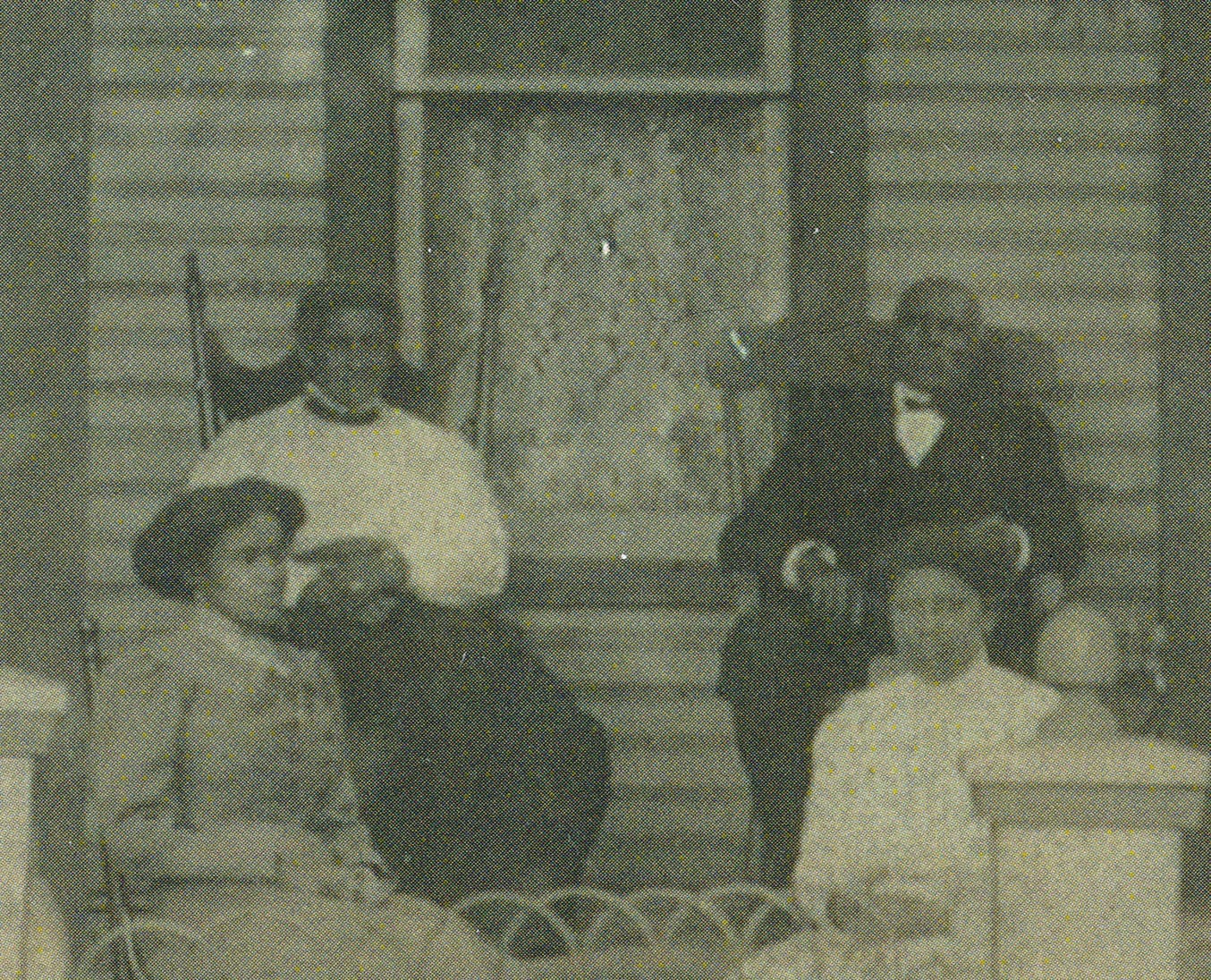Sarah and Perry Gibson sit in rocking chairs on the porch of their daughter’s home around 1910 with daughter Daisy (Gibson) Bedenbaugh and daughter-in-law Maude (Ayers) Gibson.