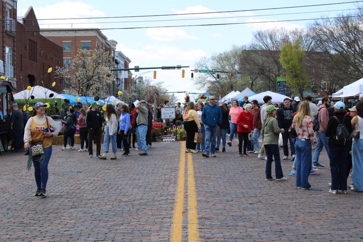 Residents walk along a closed High Street lined with vendors