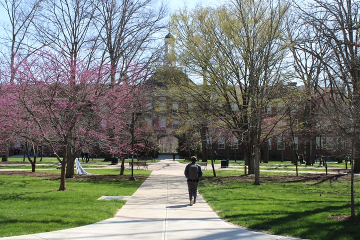 A student walks toward Upham Hall at Miami University