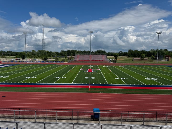 The Talawanda stadium has a green turf field with a red T in the middle