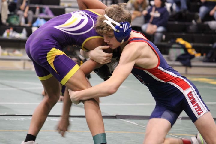 Two boys wrestle