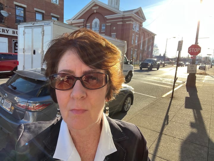 Patricia Gallagher Newberry stands outside of a courthouse