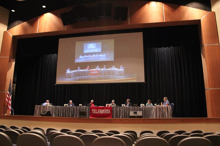 The Talawanda Board of Education gathers around a table for its monthly meeting.