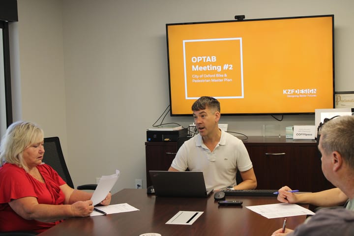 Eric Anderson (center) gives a presentation on recommendations for a Bike and Pedestrian Master Plan during a meeting at the Oxford Municipal Building