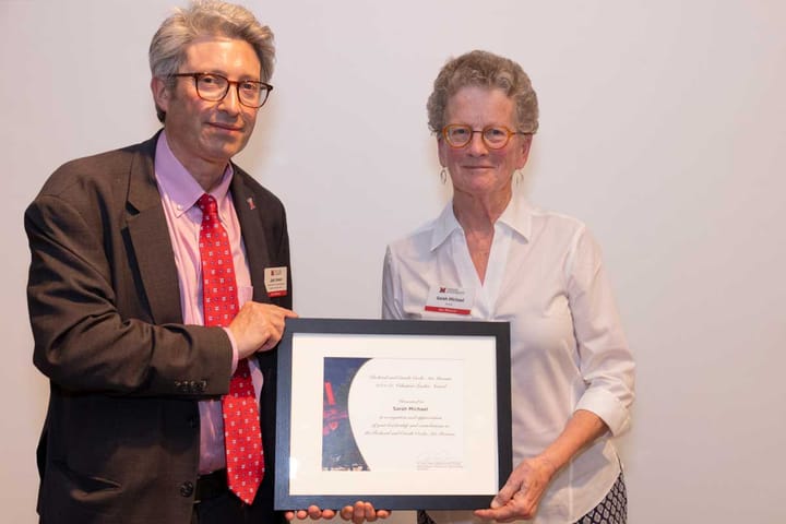 Sarah Michael (right) holds an award