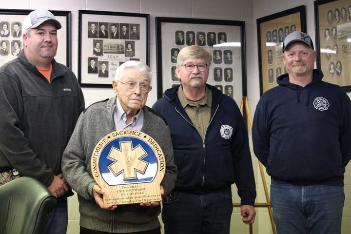 Nick Schwab, middle left, is honored during a Reily Township Board of Trustees meeting. Schwab is posed with Jeremy Sears, left, Randy Eaton and Clayton Lightfield.