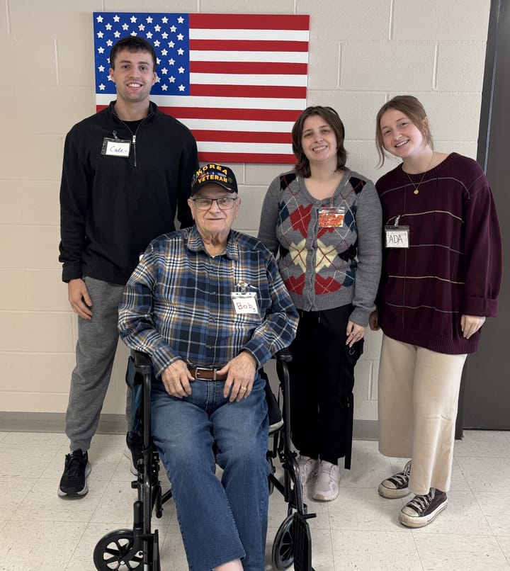 Volunteer Cade Henney, left, retired 1st Sgt. Robert Sauer, and interns Autumn Johnson and Ada Bright pose for a photo
