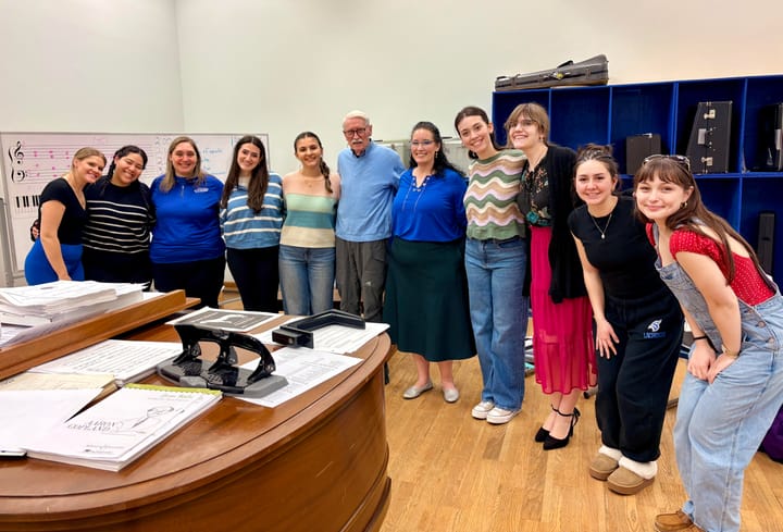 Robert Benson stands with the Dolce Women's Ensemble